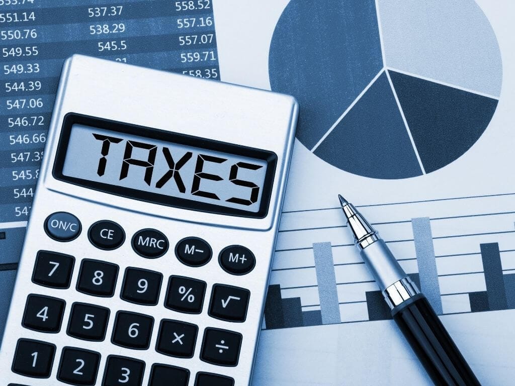a calculator showing the word taxes