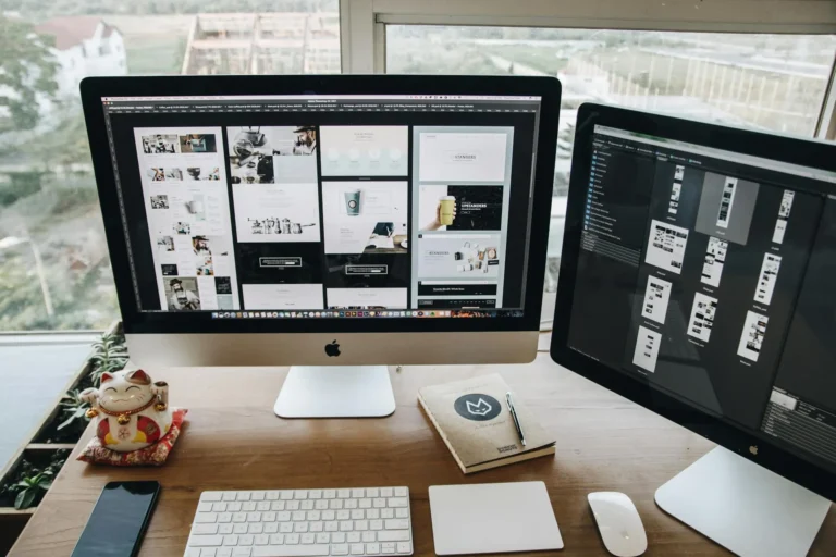 computer screens showing web design wireframes