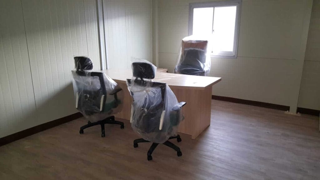 new and sealed chairs and table in an office room