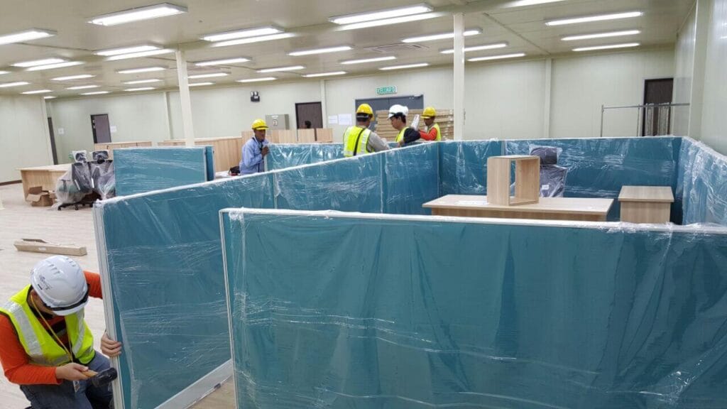 workers installing office cubicles and furniture